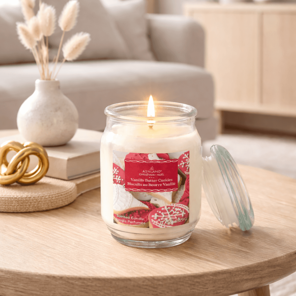 Lit Vanilla Butter Cookies scented candle in glass jar on living room table