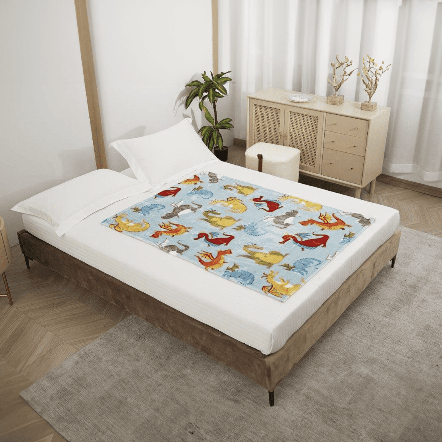 Bed with a colorful dragon themed blanket by Regal Comfort in a bedroom setting.