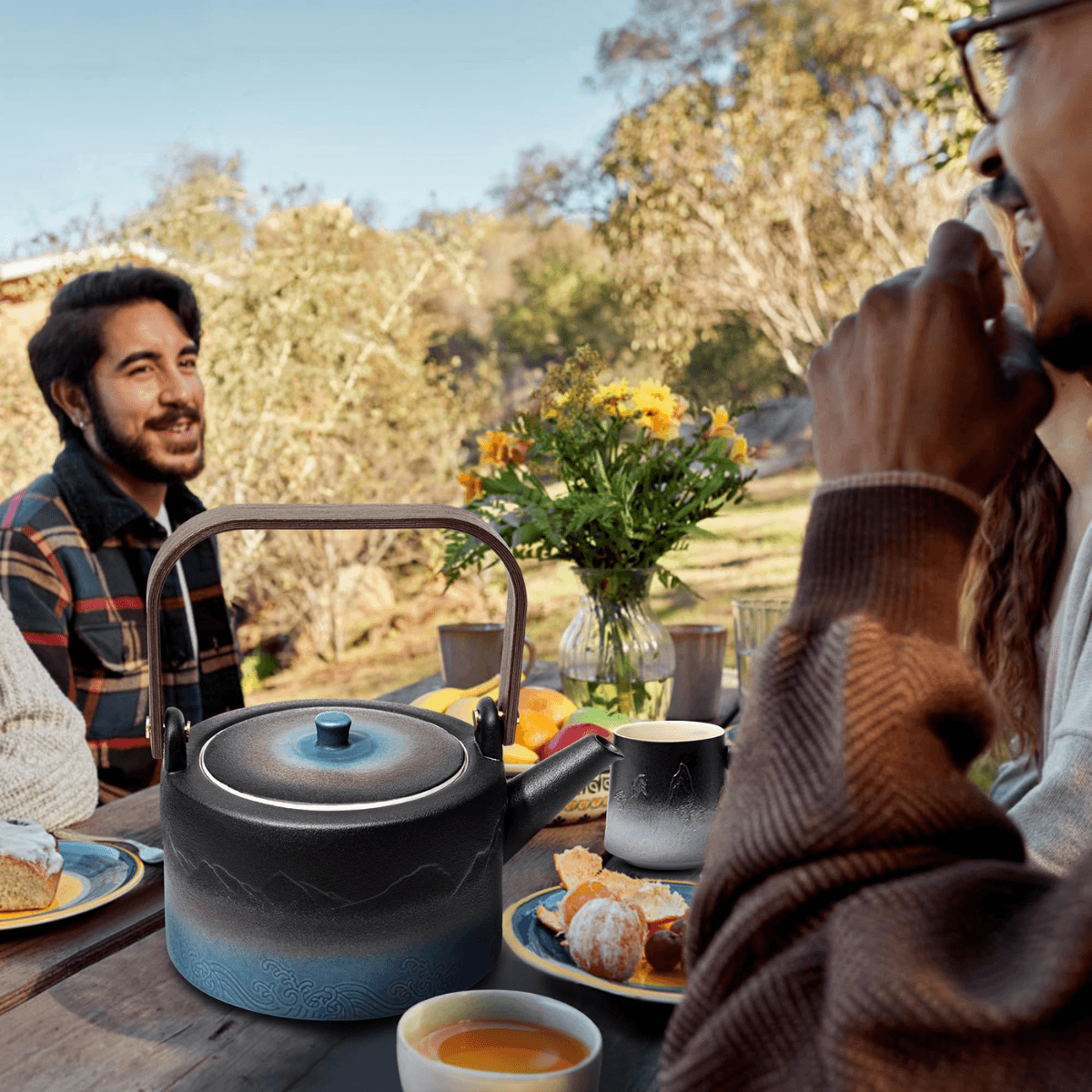 Tomotime ceramic teapot on picnic table outside.