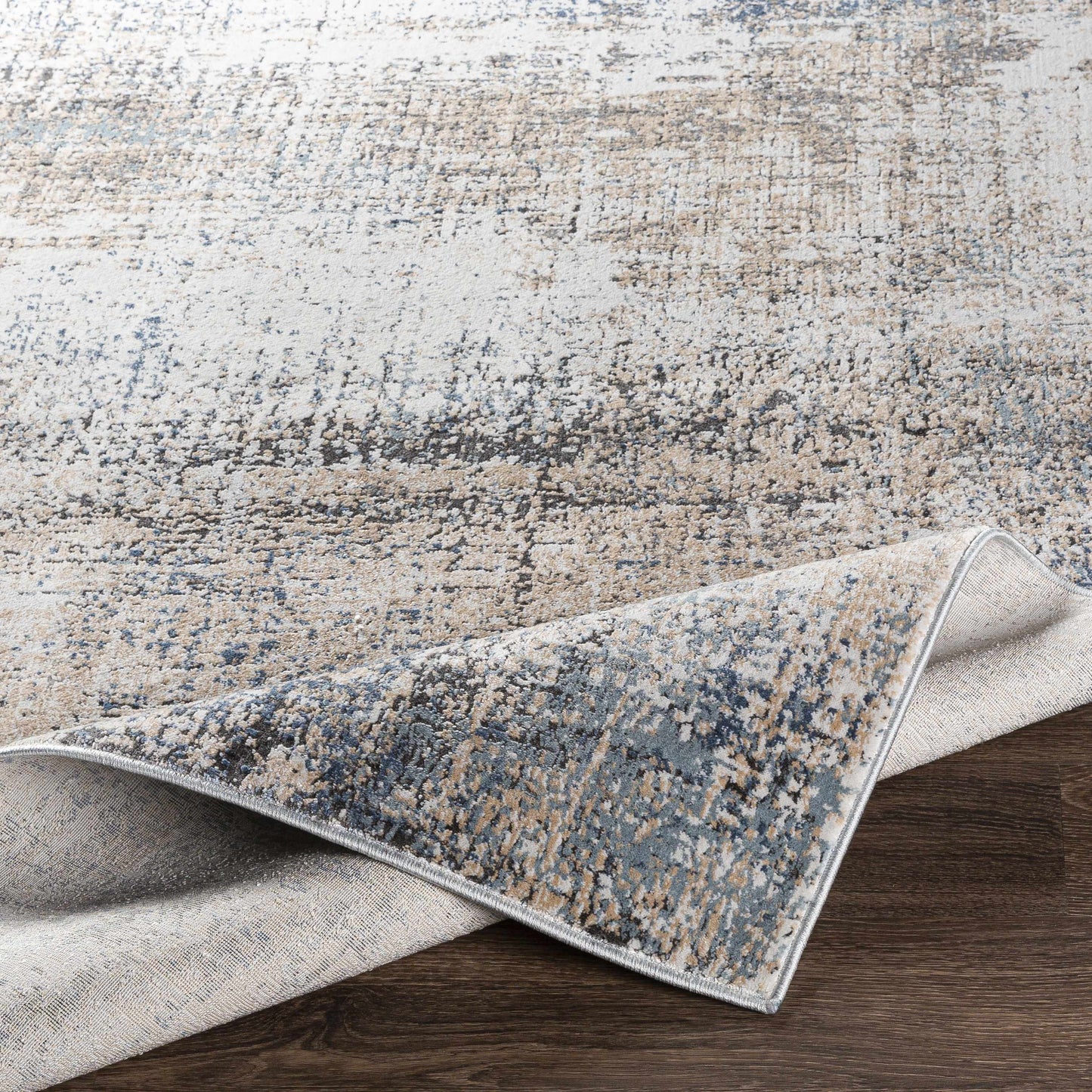 Light-colored abstract rug on dark wood