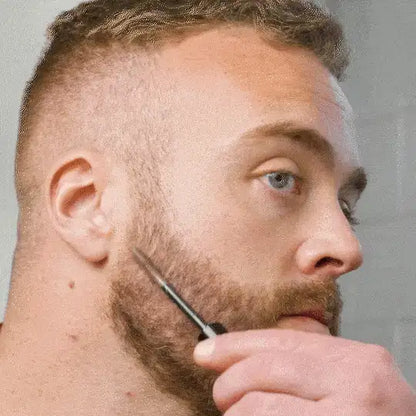 Man applying beard color with brush for grooming