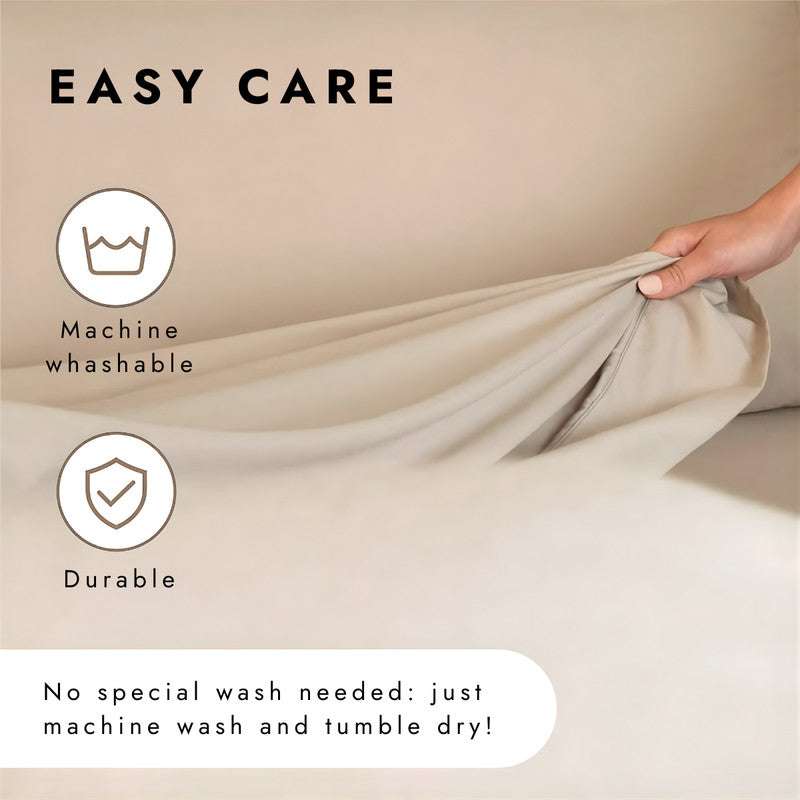 Close-up of Regal Comfort California King Sheet Set 1600 Series showing deep pocket fitted sheet being tucked, highlighting machine washable durability.