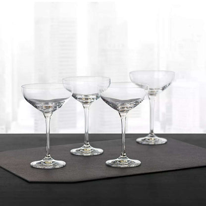 Set of four Hotel Collection Champagne Coupe Glasses 9.7 oz displayed on a dark mat, perfect for upscale home bar or entertaining settings.
