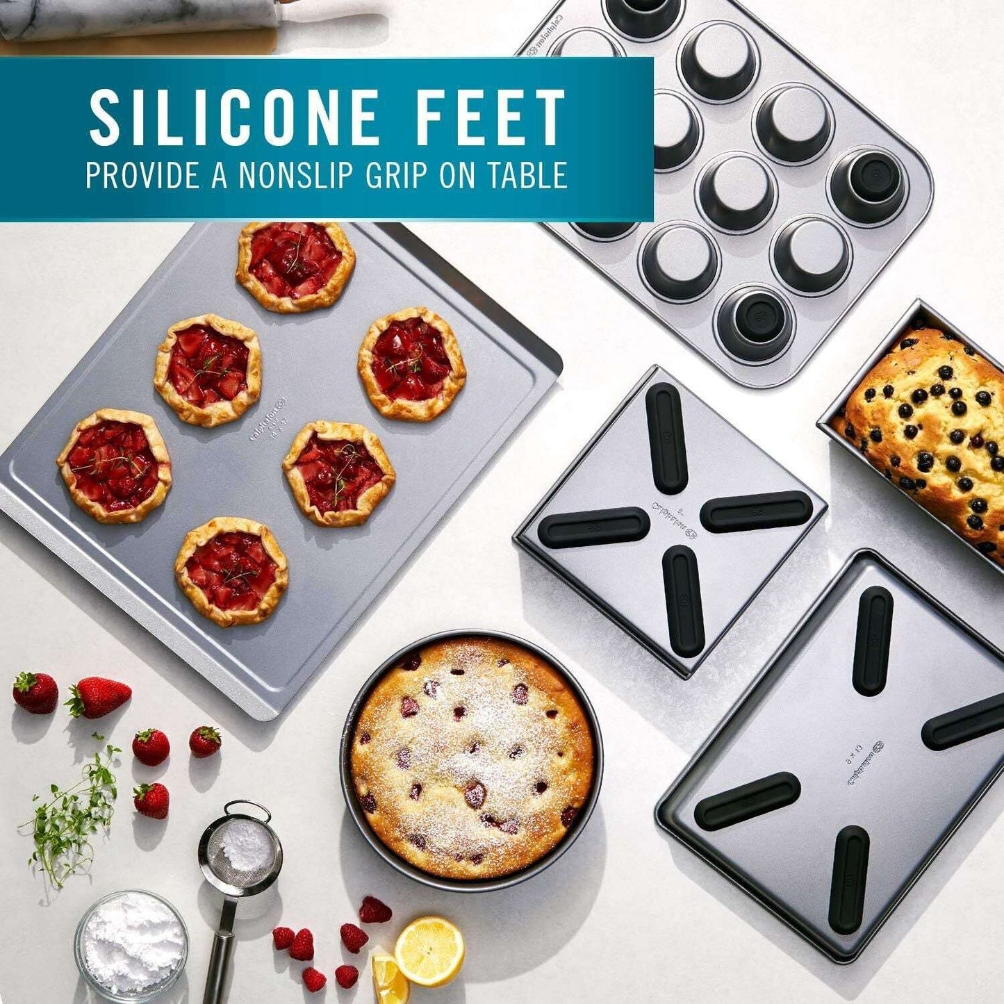 Calphalon 6 Piece Nonstick Bakeware Set Steel Baking Pans with silicone feet for nonslip grip, displayed with baked goods on a kitchen table.