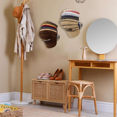 Metal Wall Mounted Cap Rack 2 Pack blends with home decor while organizing hats above a shoe bench in a cozy, modern room setting.