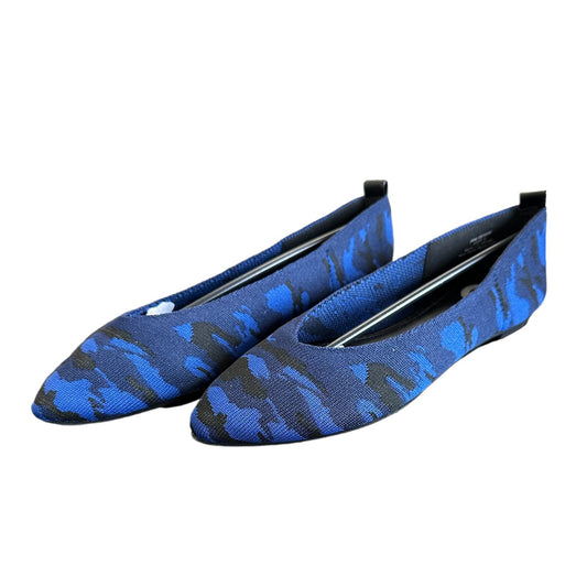 Blue camouflage-patterned flats on a white background