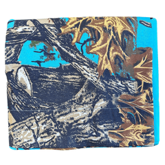 Folded The Woods Seabreeze Twin Sheet Set featuring a vibrant nature print with tree branches and autumn leaves on turquoise background.