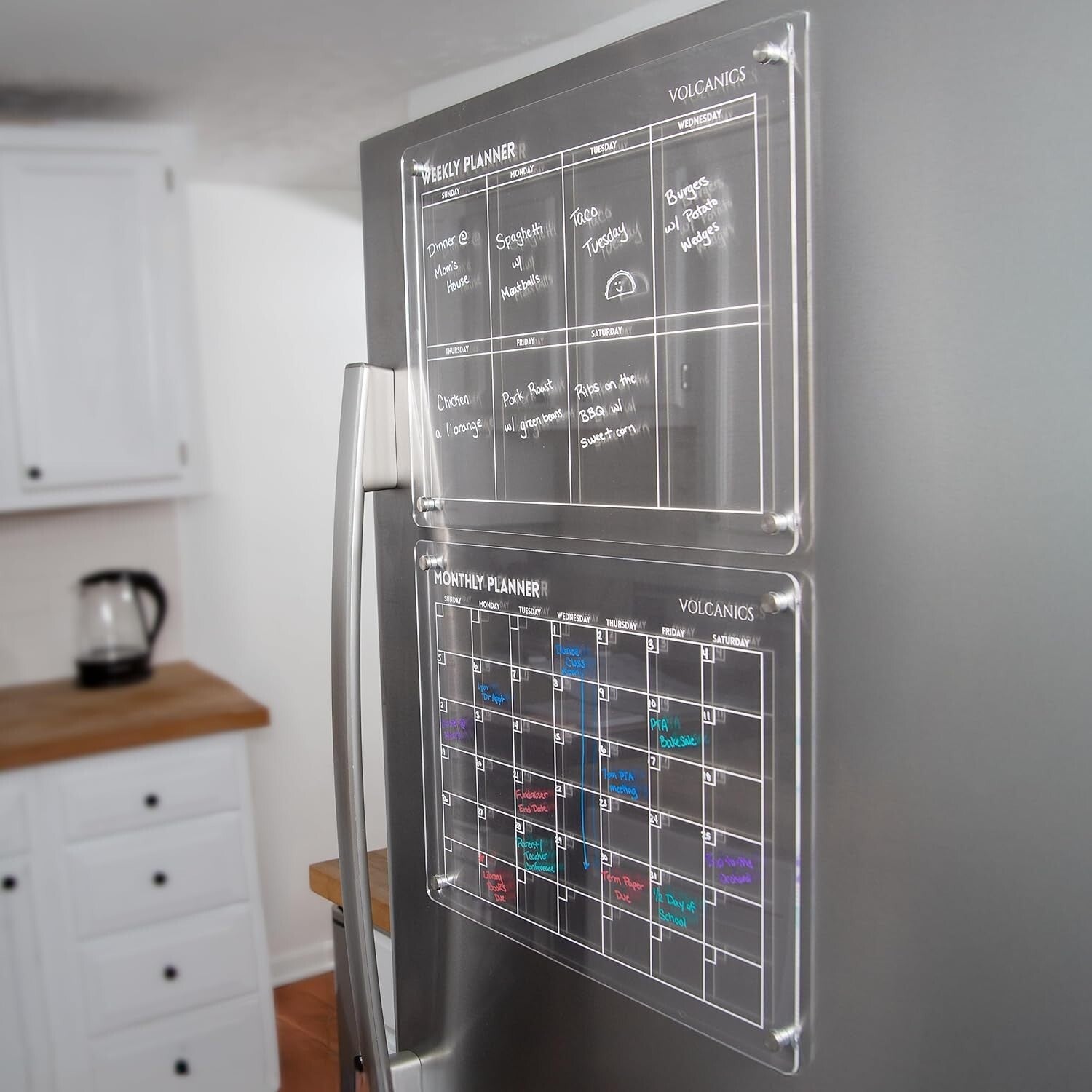 Clear acrylic Volcanics Magnetic Weekly and Monthly Planner Dry Erase Boards mounted on stainless steel fridge for modern home planning.