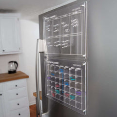 Clear acrylic Volcanics Magnetic Weekly and Monthly Planner Dry Erase Boards mounted on stainless steel fridge for modern home planning.