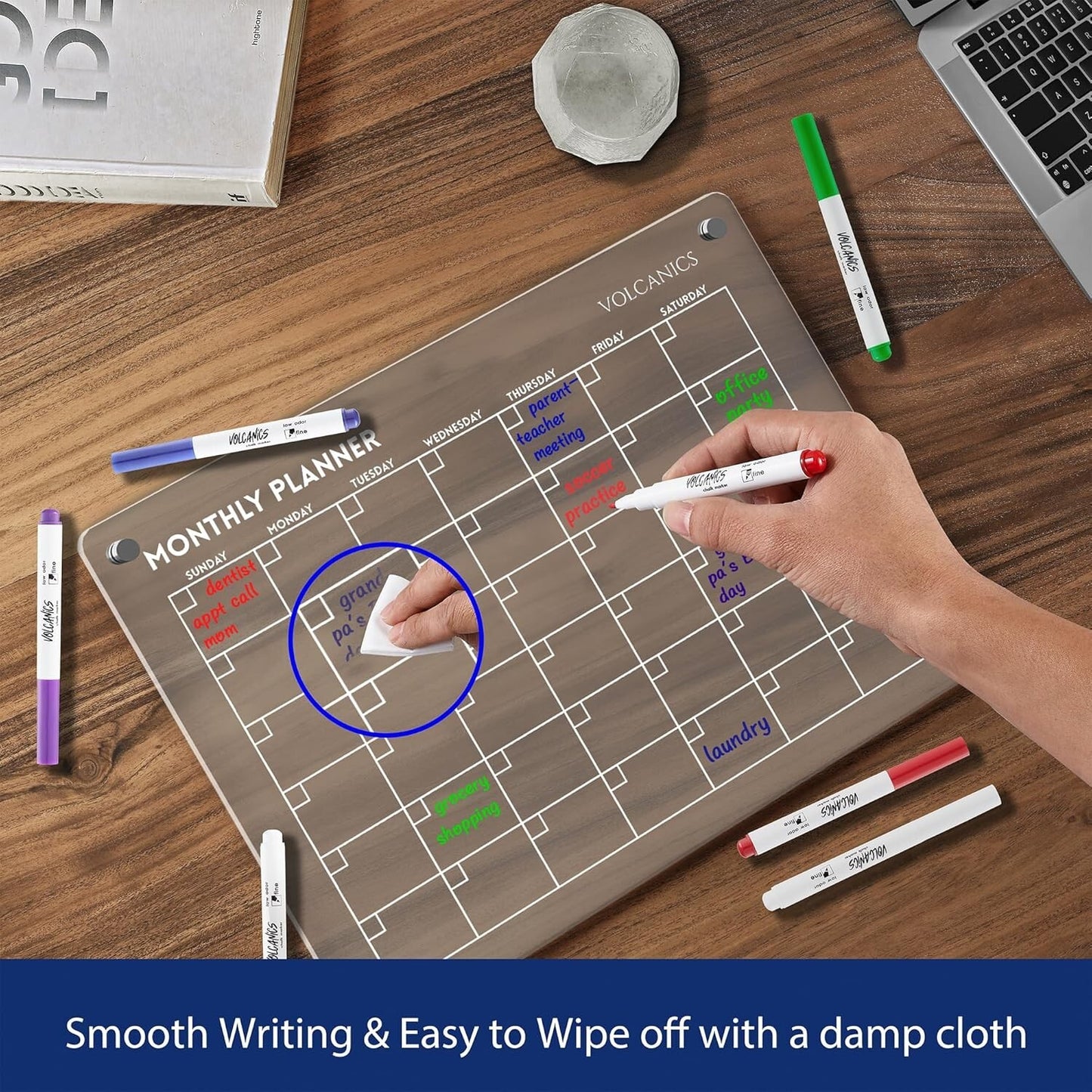 Volcanics Acrylic Magnetic Monthly Planner Dry Erase Board in use on desk, demonstrating smooth writing and easy wipe-off with damp cloth.