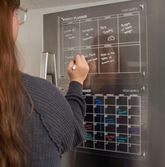 Volcanics Acrylic Magnetic Weekly Planner Dry Erase Board on fridge with handwritten weekly schedule, ideal for home or office organization.