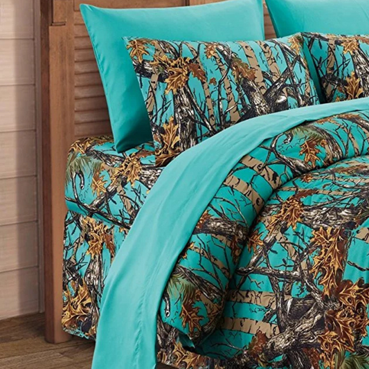 The Woods Seabreeze Twin Sheet Set with nature print and deep pocket design, shown on a bed in a rustic cabin-style room.