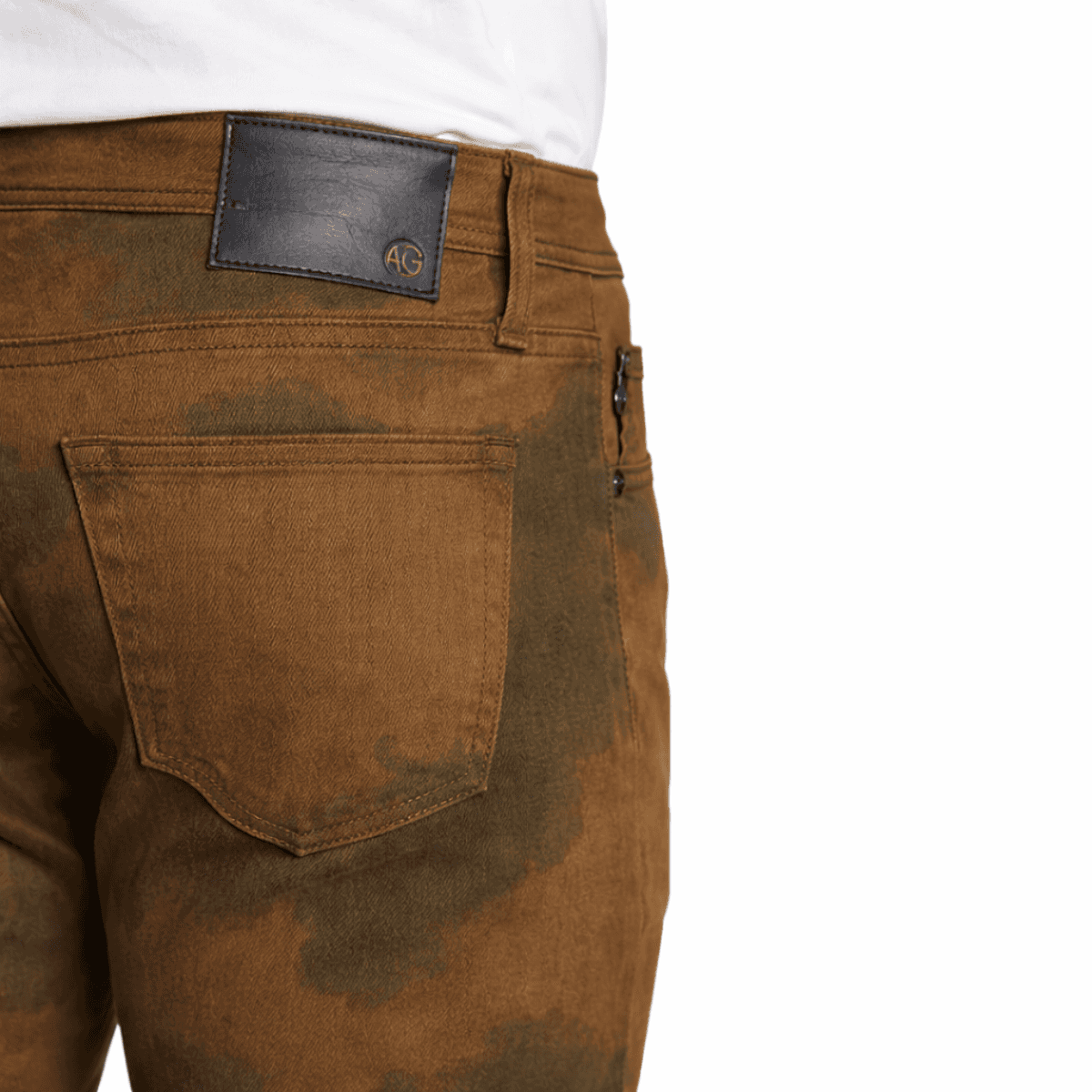 Brown jeans with a visible brand label 'AG'  on a white background