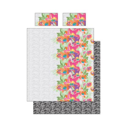 Colorful floral patterned quilt with black and white border on a white background