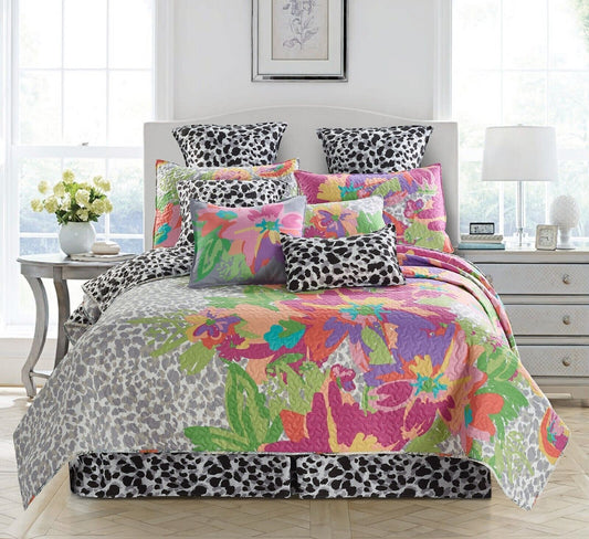 Colorful floral and animal print bedding set in a bedroom.