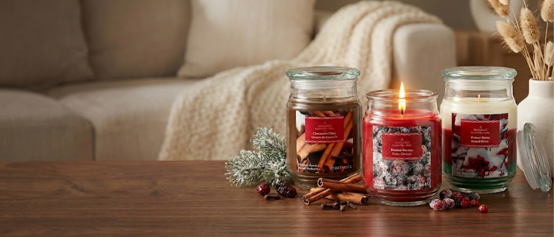 Three Ashland scented jar candles on a wood coffee table in a living room setting.