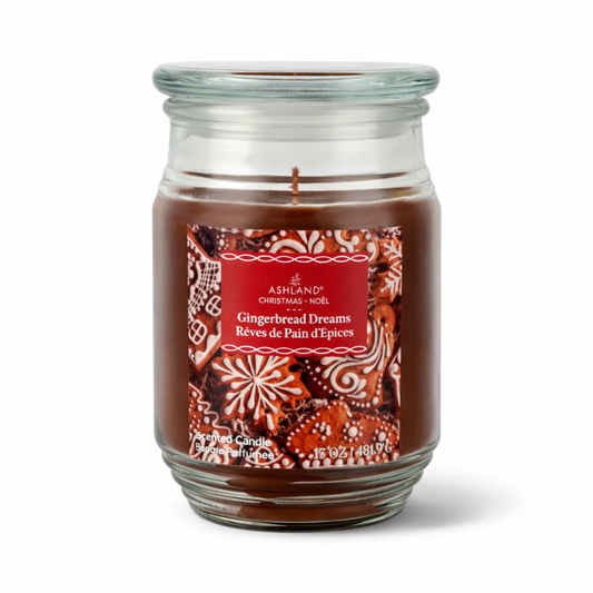 Glass candle jar with gingerbread design, labeled 'Gingerbread Dreams' on a white background