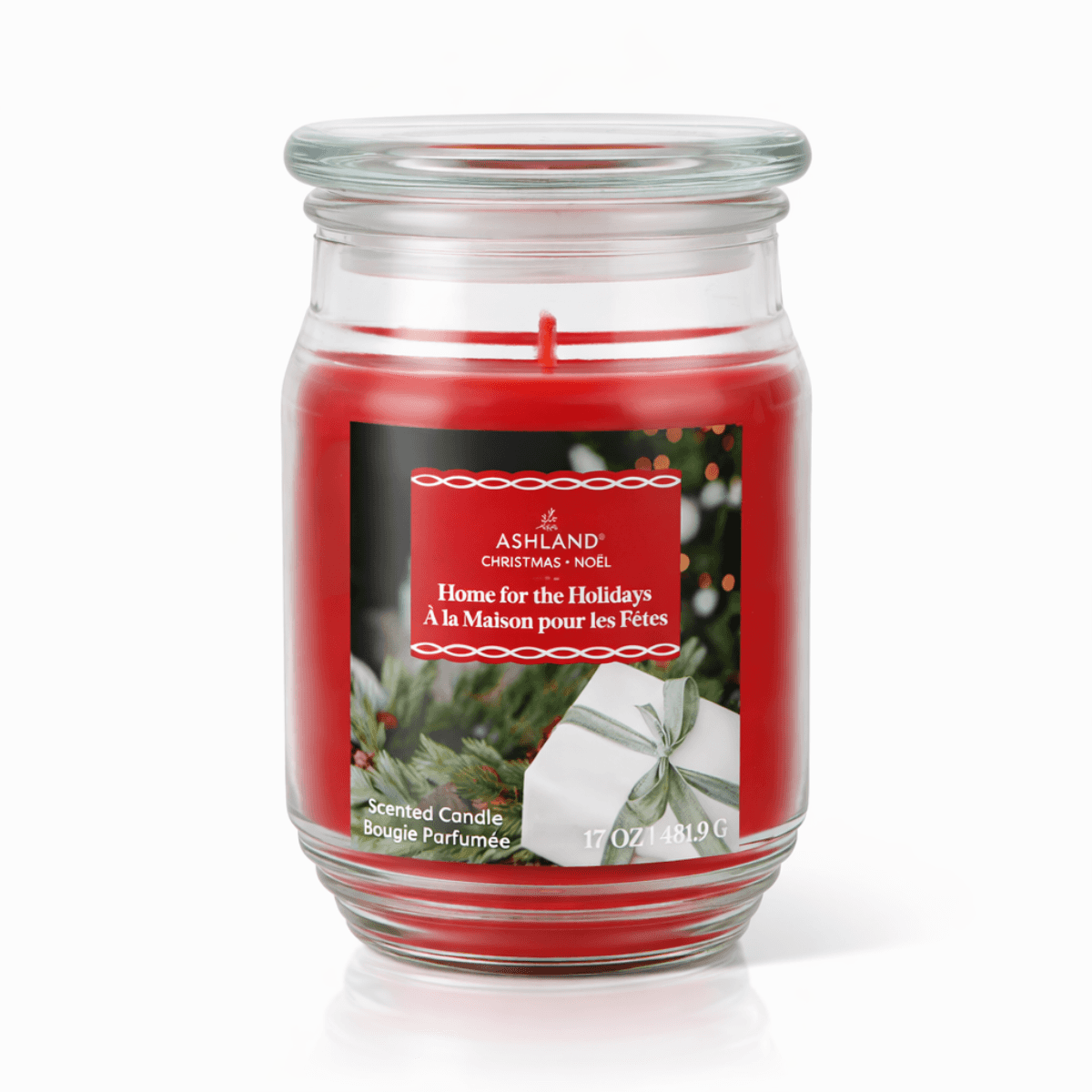 Red scented jar candle with holiday label in glass jar for home decor