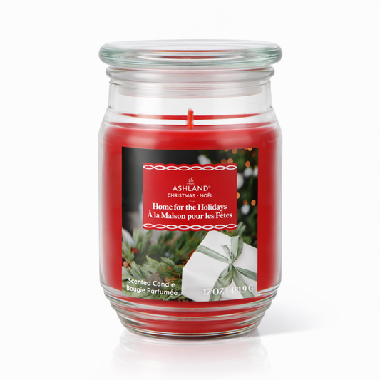 Ashland 'Home for the Holidays' glass candle jar with a red label featuring Christmas-themed graphics on a white background