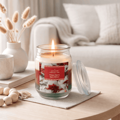 Candle with a decorative label 'Winter Berry' on a table in a cozy living room setting