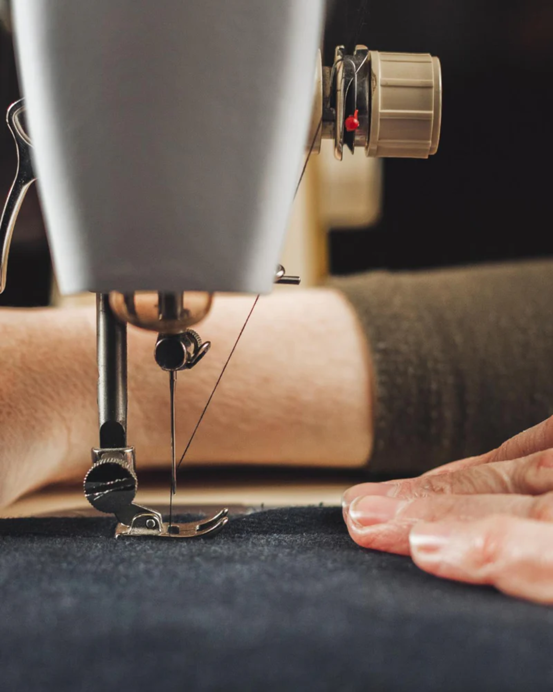 Seamstress working on one of Bagby's phone holder products