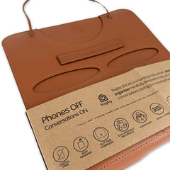 Brown leather organizer with a cardboard label on a white background