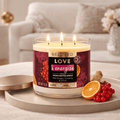 Lit candle with orange slices, red berries, and a cozy background setting
