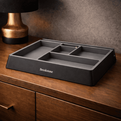 Gray Brookstone tray on a wooden surface with a gold lamp in the background