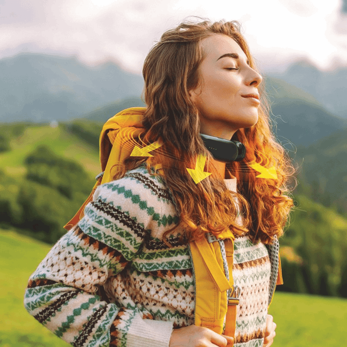 Woman wearing wearable neck heater outdoors