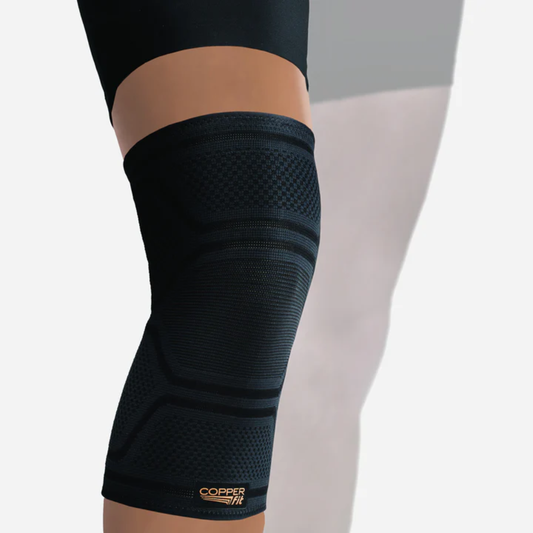 Copper Fit Elite Compression Knee Sleeve Support shown on leg, offering snug fit and flexible support for active use and daily wear.