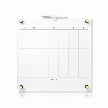 Clear acrylic dry erase calendar with white surface and gold magnets for office organization