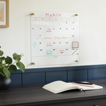 Wall-mounted dry erase calendar with colorful handwritten notes for planning and scheduling