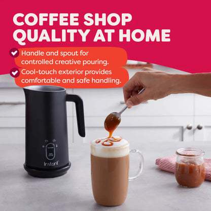 Black milk frother with a hand pouring syrup into a coffee cup on a kitchen counter, against a pink background with text about product features.