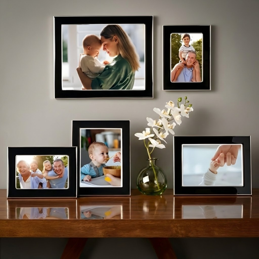 Mikasa Black & Silver 5-Piece Picture Frame Set displayed on wall and table with family photos. Elegant mix of vertical and horizontal frames.