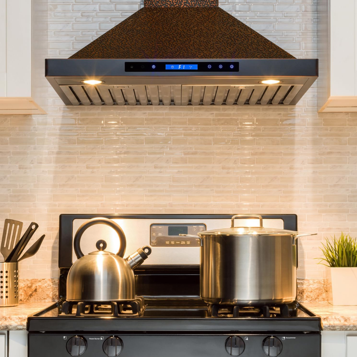 Stove with pots and a kettle in a kitchen setting