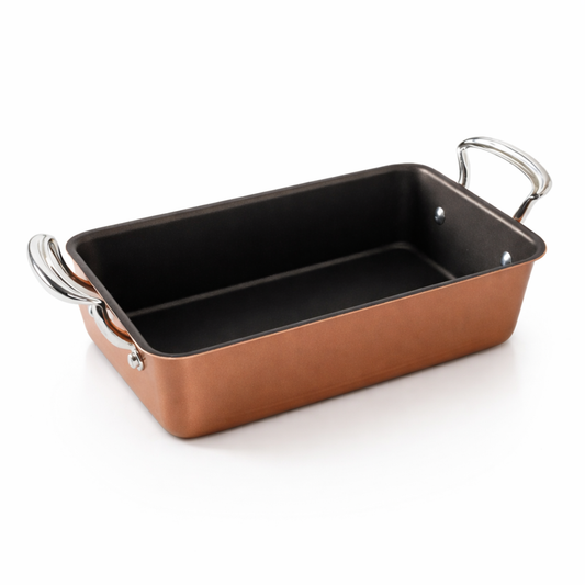 Rectangular Nordic Ware  baking dish with copper color exterior and black interior on a white background
