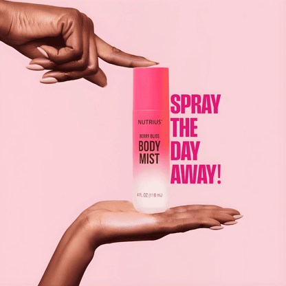 Hands holding Nutrius Berry Bliss Body Mist with pink and white background