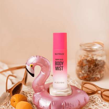 Nutrius Berry Bliss Body Mist Spray 4 oz in pink bottle with flamingo float, sunglasses, and jar of dried flowers