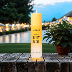Nutrius Coconut Body Mist Spray Coco Bliss 4 oz on wooden table at sunset, perfect for evening wear with a soft, tropical aroma.