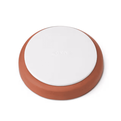 Round white and terracotta food storage container lid
