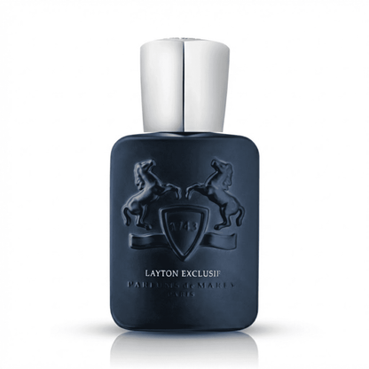 Man in suit applying Layton Exclusif perfume in elegant room