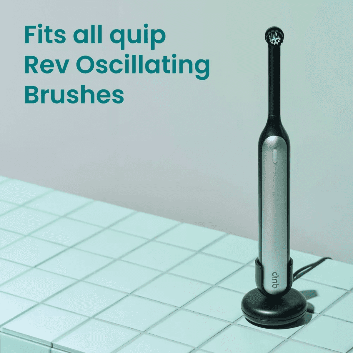 qup Rev oscillating toothbrush with replacement heads on stand