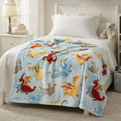 Dragon printed fleece blanket by Regal Comfort draped on the edge of a children's bed