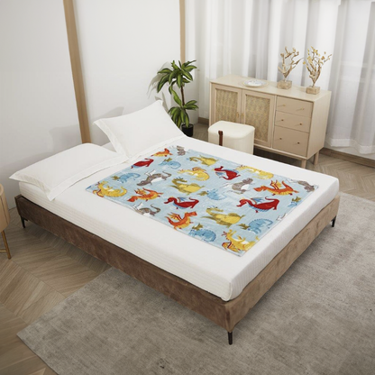 Bed with a colorful dragon themed blanket by Regal Comfort in a bedroom setting.