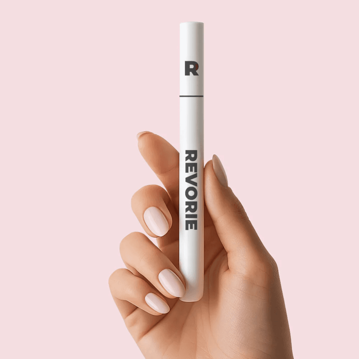 Hand holding Revorie Precision Brow Pen in Taupe for eyebrow enhancement