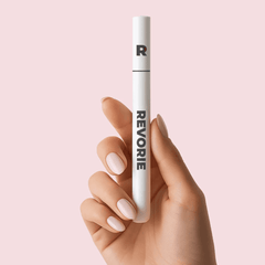 Hand holding Revorie Precision Brow Pen in Taupe for eyebrow enhancement