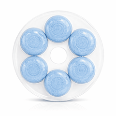 Close-up of blue dissolving toilet bowl cleaner tablets in container