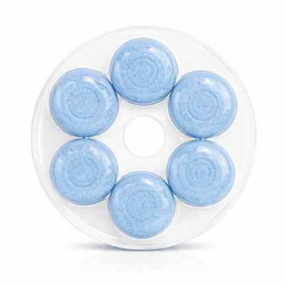 Close-up of blue dissolving toilet bowl cleaner tablets in container