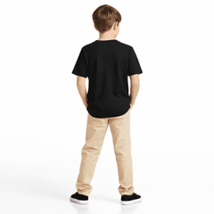 Back view of child wearing novelty St. Patricks day t-shirt and beige pants on a white background