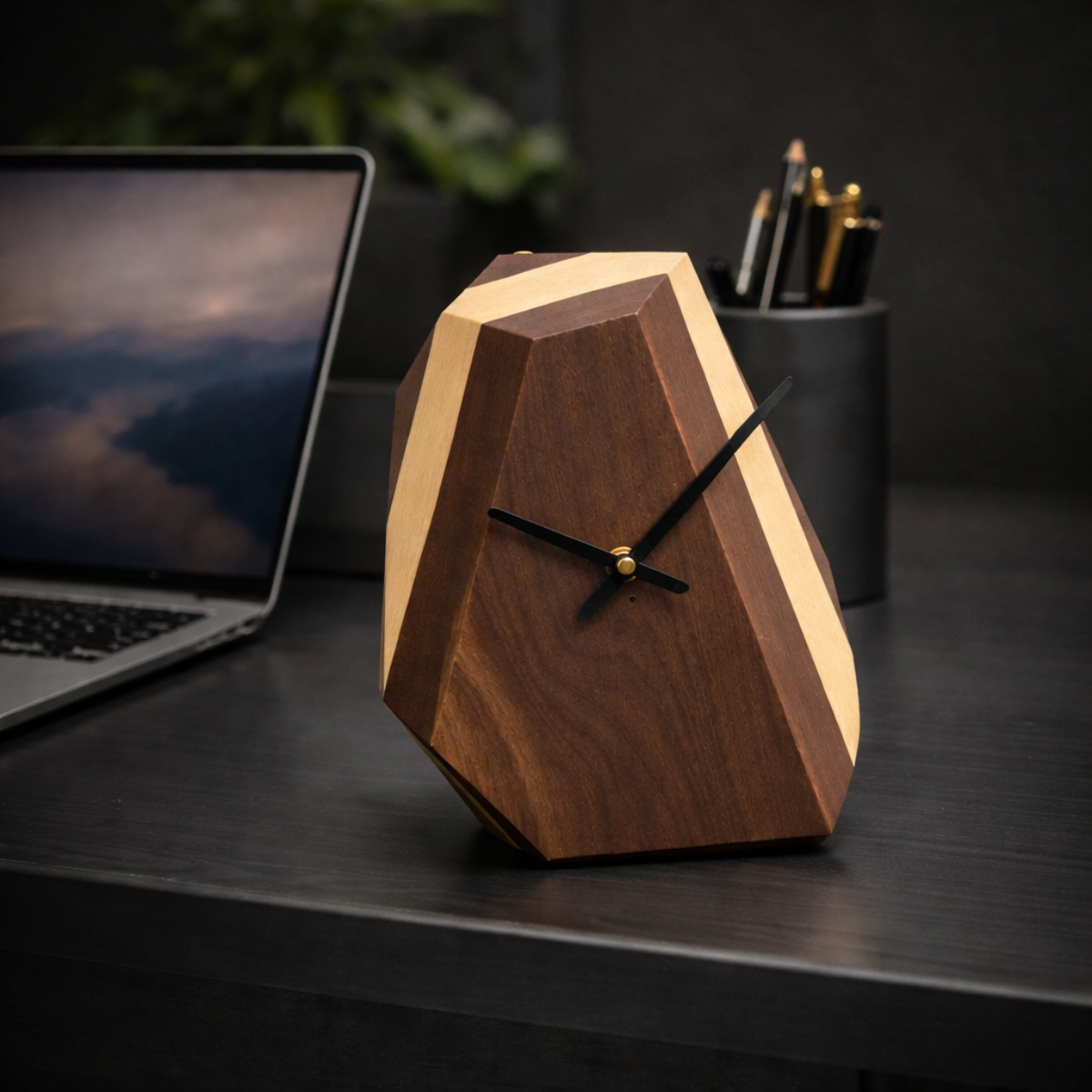 Wooden geometric clock on a desk with a laptop and pen holder in the background